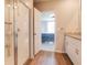 Bathroom featuring a glass-enclosed shower and vanity with granite countertops, leading to main bedroom at 719 Tortugas St, Haines City, FL 33844