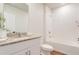 Bright bathroom featuring granite countertops, white cabinetry, and a tiled shower/tub at 719 Tortugas St, Haines City, FL 33844