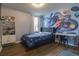 ' bedroom featuring space-themed mural, playful decor, and comfortable furnishings at 719 Tortugas St, Haines City, FL 33844