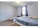 This bedroom has two beds, wood-look flooring, natural light from the window, and neutral wall paint at 719 Tortugas St, Haines City, FL 33844