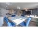 Open-concept dining and living area with bright, modern furniture and decor and kitchen views at 719 Tortugas St, Haines City, FL 33844