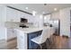 Modern kitchen featuring white cabinets, marble countertops, stainless steel appliances, and pendant lighting at 719 Tortugas St, Haines City, FL 33844