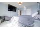 Main bedroom with light blue walls, white floors, and a plush upholstered bed at 719 Tortugas St, Haines City, FL 33844