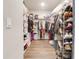 Spacious walk-in closet with ample storage shelves and hanging racks for clothes and shoes at 719 Tortugas St, Haines City, FL 33844