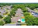 A high angle view of backyard pools bordered by white fences in a neighborhood with mature landscaping at 7288 Winding Lake Cir, Oviedo, FL 32765