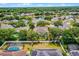 Aerial view of the property with yard outlined in red, featuring in-ground pool, trees, and lake at 7288 Winding Lake Cir, Oviedo, FL 32765