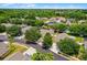 Aerial view of the property with yard outlined in red, surrounded by mature trees at 7288 Winding Lake Cir, Oviedo, FL 32765