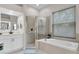Bright bathroom showcasing walk-in shower, soaking tub, and double sink vanity at 7288 Winding Lake Cir, Oviedo, FL 32765