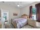 Inviting bedroom with queen bed, neutral walls, and ample natural light at 7288 Winding Lake Cir, Oviedo, FL 32765