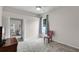 Cozy bedroom featuring a soft grey carpet, a chair, a TV, and natural light at 7288 Winding Lake Cir, Oviedo, FL 32765