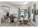 Cozy dining area featuring built-in desk, round table, and large windows with sun-softening curtains at 7288 Winding Lake Cir, Oviedo, FL 32765