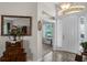Inviting foyer with tiled floor and decoratively mirrored table at 7288 Winding Lake Cir, Oviedo, FL 32765