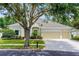 Charming single-story home with well-manicured lawn, mature landscaping, and a three car garage at 7288 Winding Lake Cir, Oviedo, FL 32765