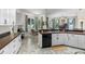 Bright kitchen with white cabinets, sleek countertops, stainless sink, and natural light pouring in from large windows at 7288 Winding Lake Cir, Oviedo, FL 32765
