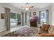 Bright living room with large windows, and access to the pool area at 7288 Winding Lake Cir, Oviedo, FL 32765