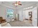 Bright room with a ceiling fan, neutral carpet, and a large window providing a lot of natural light at 7288 Winding Lake Cir, Oviedo, FL 32765