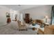 Welcoming living room featuring plush carpet and views of the foyer and dining room at 7288 Winding Lake Cir, Oviedo, FL 32765