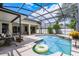 View of the screened-in pool with patio, seating, and beautiful backyard landscaping at 7288 Winding Lake Cir, Oviedo, FL 32765