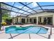 A screened-in backyard pool with patio seating and exterior view of the house at 7288 Winding Lake Cir, Oviedo, FL 32765