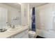 Bathroom features a shower/tub combo with a blue curtain and a white vanity at 7663 Fitzclarence St, Kissimmee, FL 34747