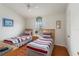 Bedroom features two twin beds, a window, and a ceiling fan at 7663 Fitzclarence St, Kissimmee, FL 34747