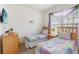 Bright bedroom with twin beds, plush bedding and bright natural light at 7663 Fitzclarence St, Kissimmee, FL 34747