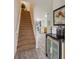 Bright entryway with a staircase, tiled floors, and decorative display, creates an inviting transition to the living spaces at 7663 Fitzclarence St, Kissimmee, FL 34747