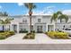 Charming townhomes with lush landscaping, paved driveways, and inviting blue exteriors create an appealing curb presence at 7663 Fitzclarence St, Kissimmee, FL 34747