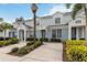 Townhome complex features light blue paint, white trim, and well-manicured landscaping, creating a clean and inviting atmosphere at 7663 Fitzclarence St, Kissimmee, FL 34747