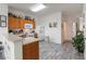 Bright kitchen features wood cabinets, white appliances and updated flooring at 7663 Fitzclarence St, Kissimmee, FL 34747