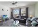 Cozy living room with large windows, comfortable seating, and contemporary decor, creating a relaxing living area at 7663 Fitzclarence St, Kissimmee, FL 34747