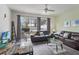 Comfortable living room with patio access, modern decor, and stylish furniture, perfect for relaxation and entertaining at 7663 Fitzclarence St, Kissimmee, FL 34747