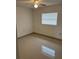 A cozy bedroom with tile flooring, a ceiling fan, and a large window for plenty of natural light at 767 Willie Mays Pkwy, Orlando, FL 32811