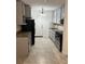 A modern kitchen with stainless steel appliances, granite countertops, and updated cabinetry at 767 Willie Mays Pkwy, Orlando, FL 32811