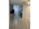 Open floor plan with tile flooring and a ceiling fan, seamlessly connecting to a modern kitchen at 767 Willie Mays Pkwy, Orlando, FL 32811