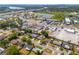Aerial view of neighborhood showcasing the homes, nearby roads, retail locations, and a beautiful pond at 808 Malone Dr, Orlando, FL 32810