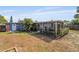 Spacious backyard showcasing an enclosed patio, perfect for entertaining, and a glimpse of the home's bright exterior at 808 Malone Dr, Orlando, FL 32810