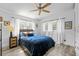 Inviting bedroom featuring a cozy bed with blue bedding, complemented by natural light and neutral decor at 808 Malone Dr, Orlando, FL 32810