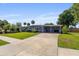 Single-story home featuring a covered carport, mature landscaping, and a well-maintained lawn at 808 Malone Dr, Orlando, FL 32810