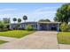Charming single-story home featuring a covered carport, well-maintained lawn, and mature landscaping at 808 Malone Dr, Orlando, FL 32810