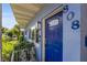 Inviting entryway with a stylish blue front door, decorative sidelight window, and manicured garden at 808 Malone Dr, Orlando, FL 32810