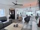 Open concept living room with neutral color palette, ceiling fans, and eat-in kitchen at 808 Malone Dr, Orlando, FL 32810