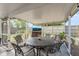 Covered patio with dining table set and mounted TV, perfect for outdoor entertaining and relaxation at 808 Malone Dr, Orlando, FL 32810