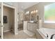 Luxurious bathroom featuring a walk-in shower, soaking tub, and double sink vanity at 9534 Piccadilly Sky Way, Orlando, FL 32827