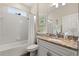 Bright bathroom with tiled shower-tub combo, granite countertop, and coastal decor at 9534 Piccadilly Sky Way, Orlando, FL 32827