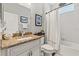 Bright bathroom with tiled shower-tub combo, granite countertop, and coastal decor at 9534 Piccadilly Sky Way, Orlando, FL 32827