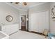 Cozy bedroom with neutral walls, white trim, a double door closet, and a decorative mirror at 9534 Piccadilly Sky Way, Orlando, FL 32827