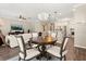 Open-concept dining area with chandelier, hardwood floors, and view to kitchen at 9534 Piccadilly Sky Way, Orlando, FL 32827