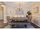 Formal dining room features bench seating, modern lighting fixture, and hardwood floors at 9534 Piccadilly Sky Way, Orlando, FL 32827
