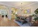 Open dining area featuring a wooden table with bench seating and views of the living room at 9534 Piccadilly Sky Way, Orlando, FL 32827